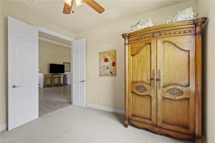 Bedroom with light carpet and ceiling fan