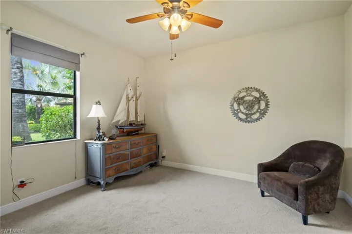 Living area featuring carpet flooring and a ceiling fan