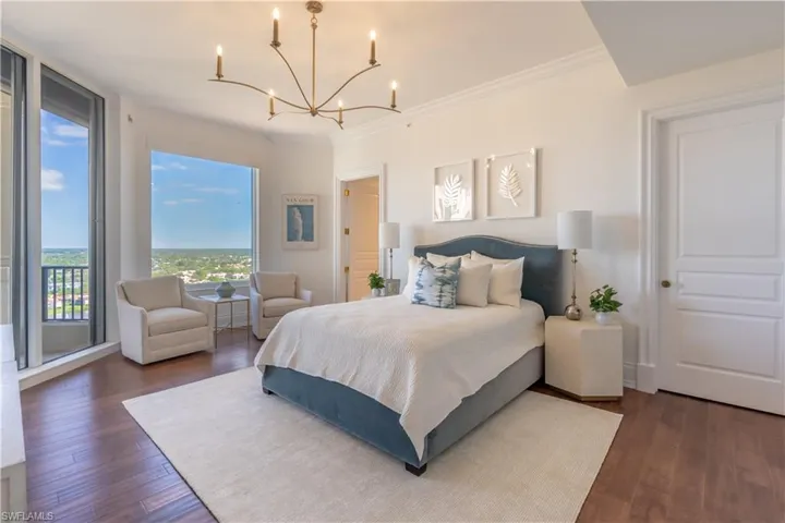 Guest bedroom with seating area and access to East balcony