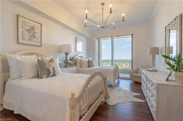Guest bedroom with two double beds and access to East balcony