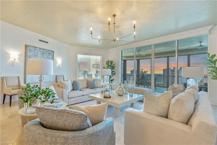 Grand salon with wall of sliding glass doors opening onto lanai