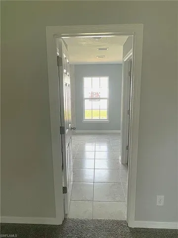 Hallway from Primary Bedroom to Primary Bathroom and two walk-in closets.
