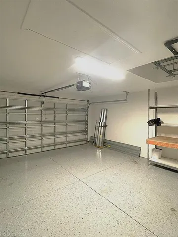 2-car Garage featuring a garage door opener and epoxy floors.