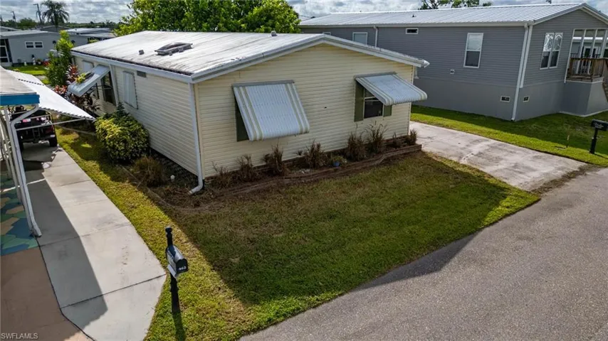 View of property exterior with a yard