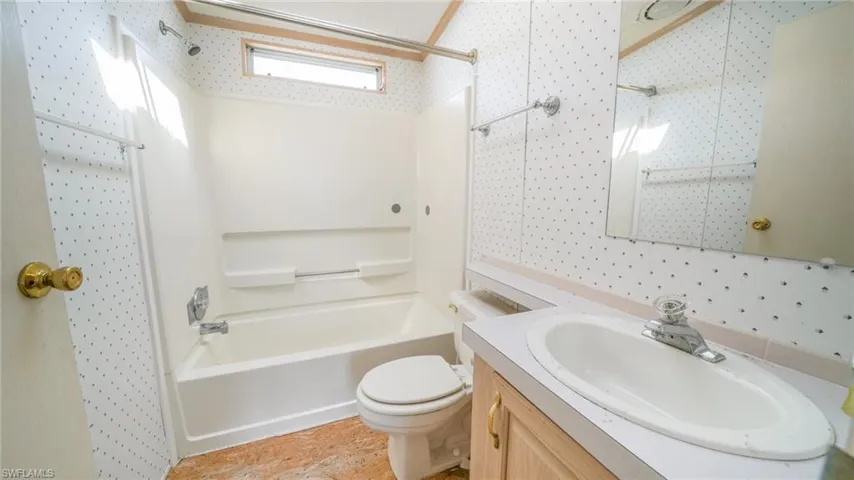 Full bathroom with toilet, shower / bathing tub combination, and vanity