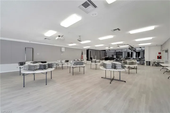 Playroom with light wood-type flooring and a textured ceiling