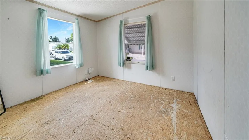 Spare room featuring ornamental molding and a textured ceiling