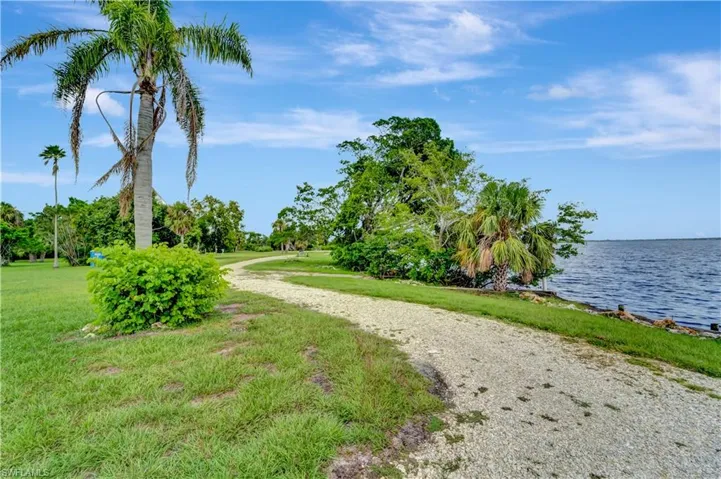View of community featuring a water view and a yard