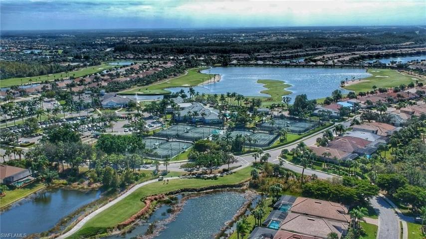 Drone shot of tennis courts and clubhouse along with various lakes and Golf Course views.