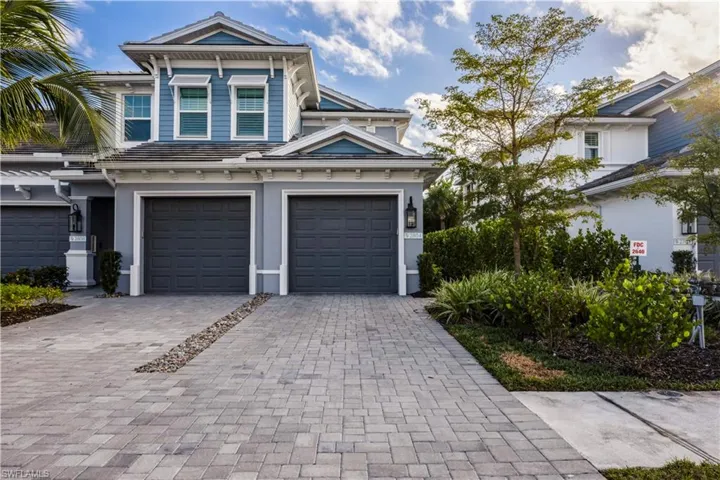 View of front of house featuring decorative driveway and an attached garage