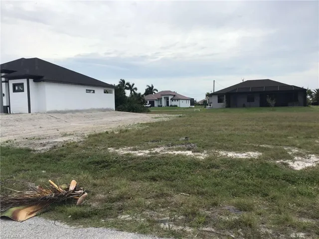 View of beautiful new construction home to the left of lot