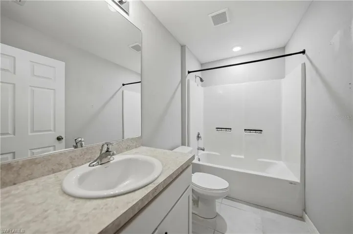 Full bathroom featuring shower / bath combination and vanity