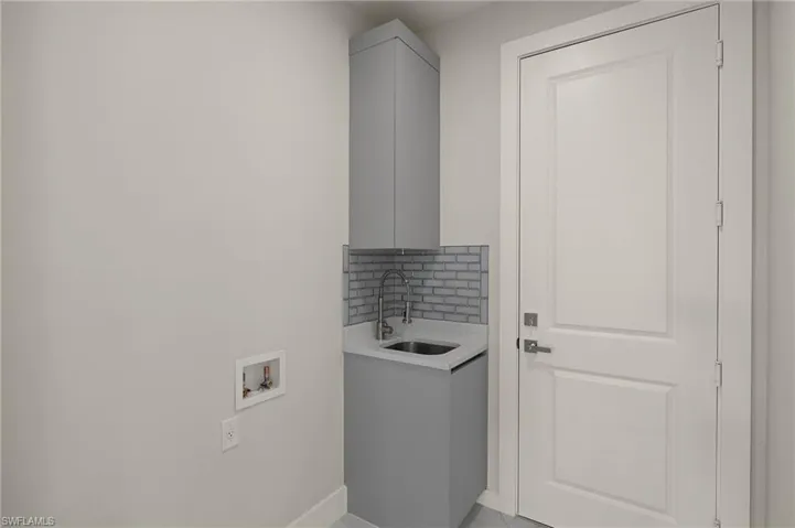 Laundry area featuring a sink and hookup for a washing machine
