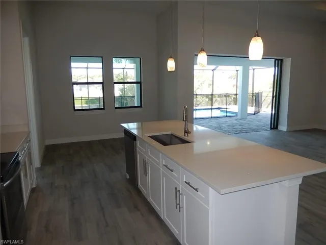 Kitchen featuring white cabinetry, electric range oven, pendant lighting, and dark wood-style flooring