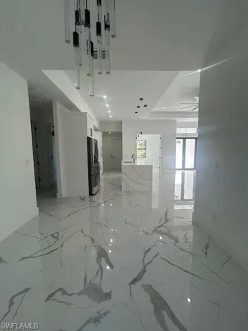 Unfurnished room featuring light marble finish floors and recessed lighting