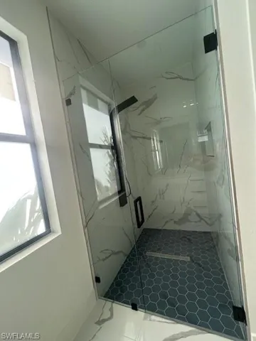 Bathroom with a marble finish shower