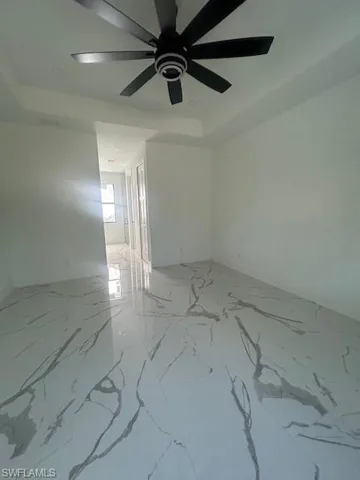 Empty room featuring light marble finish flooring