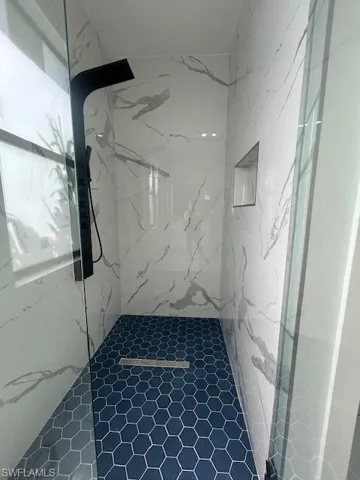 Bathroom with a marble finish shower