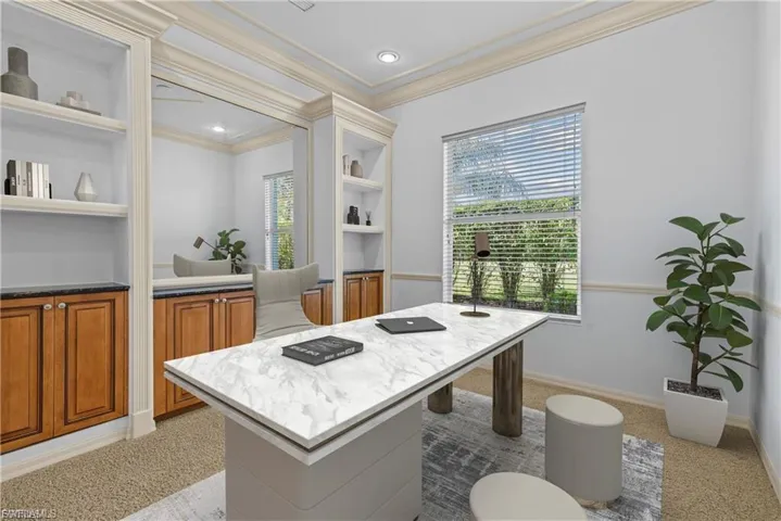 Office featuring built in shelves, light carpet, and crown molding