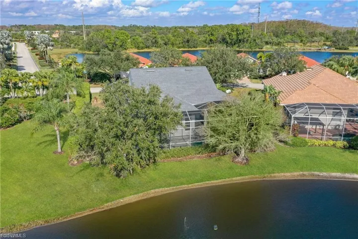 Drone / aerial view of a large body of water and a tree filled landscape