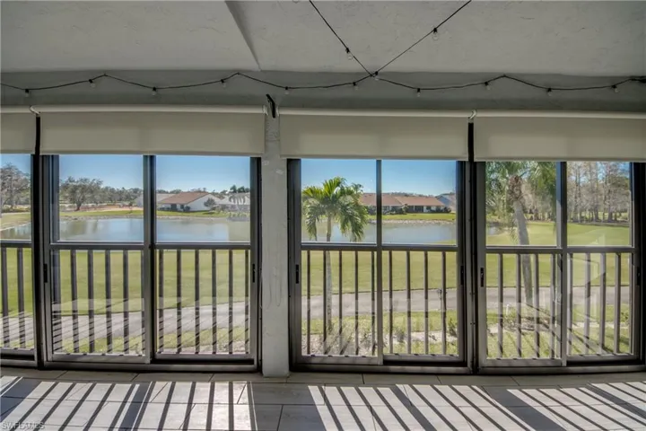 Unfurnished sunroom featuring a water view, a residential view, and plenty of natural light
