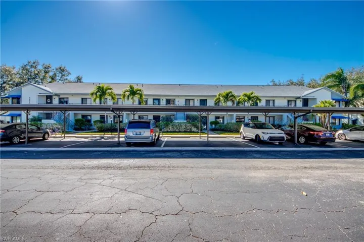 View of property featuring covered parking