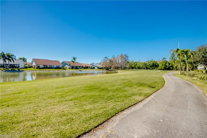 Surrounding community featuring a yard, a water view, and a residential view