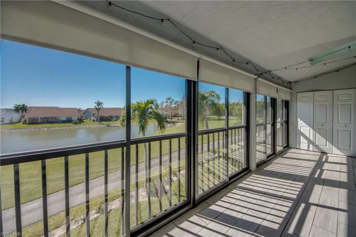 Unfurnished sunroom with vaulted ceiling and a water view