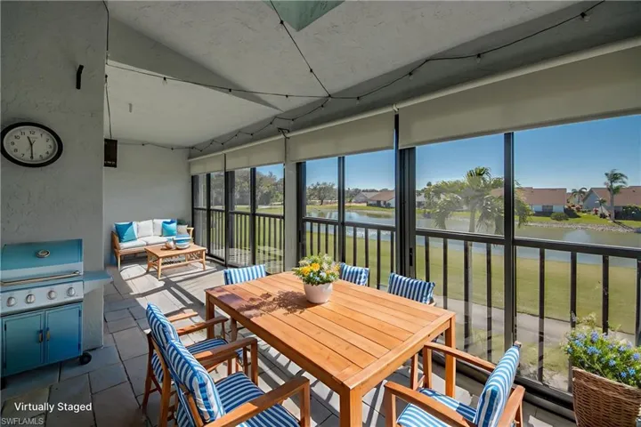 Sunroom with a water view and a textured wall