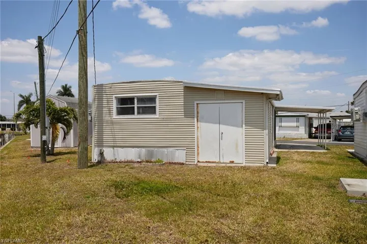 Back of property featuring a yard