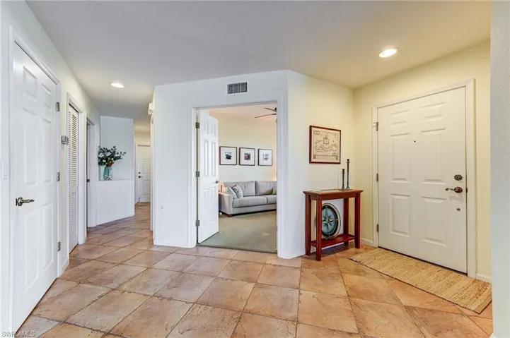 Entry vestibule, with den.  Guest room, bath, laundry and garage down this hallway