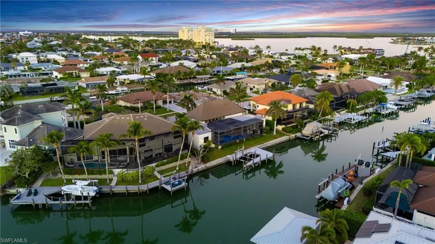 Aerial view at dusk of a water view and a residential view