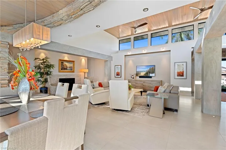 Building lobby with a towering ceiling, recessed lighting, and wooden ceiling