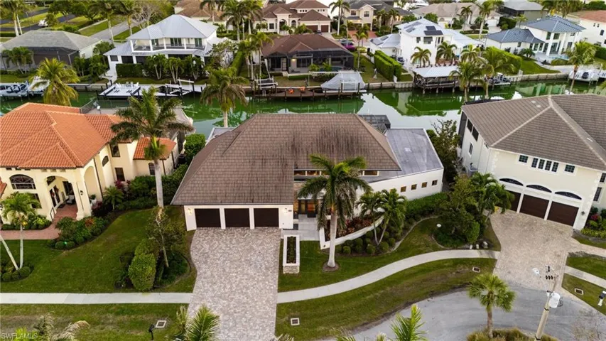 Aerial perspective of suburban area with a nearby body of water
