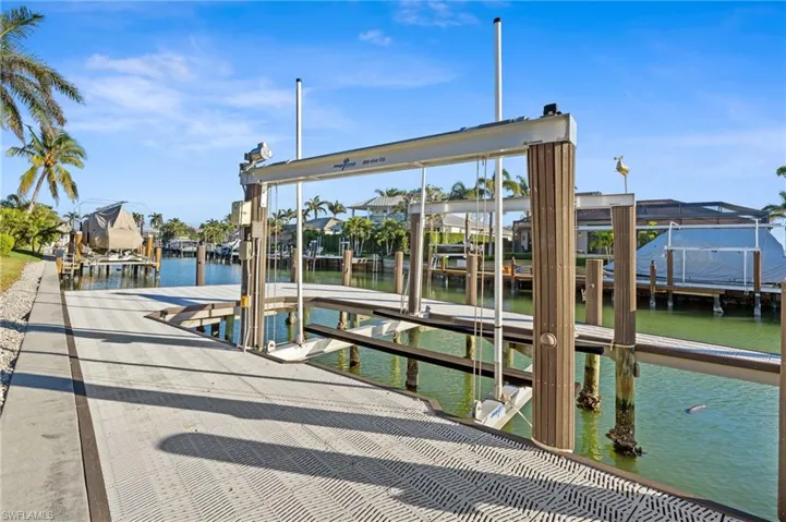 Dock with boat lift and a water view