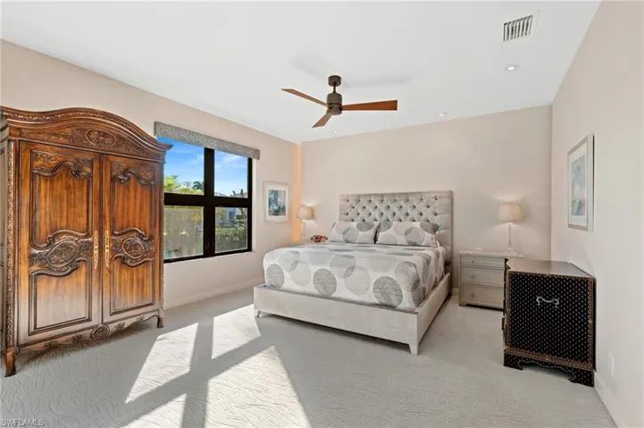 Bedroom featuring light carpet and ceiling fan