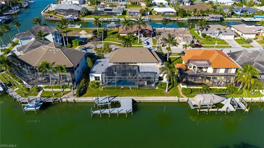 Aerial view of residential area featuring a nearby body of water