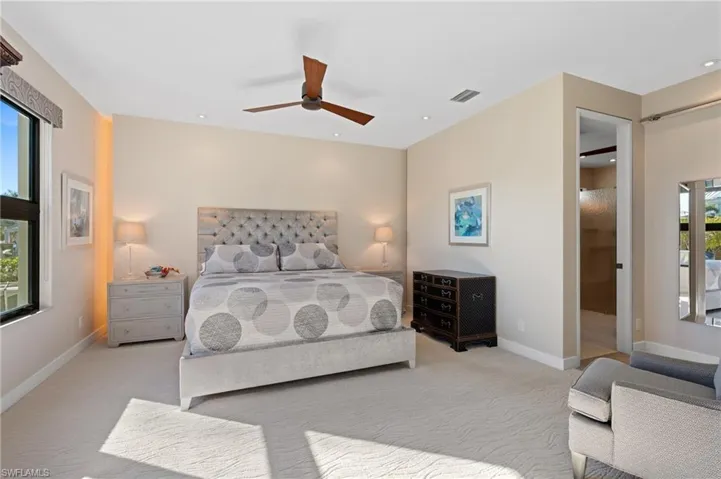 Carpeted bedroom featuring a ceiling fan and recessed lighting
