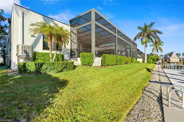 View of grassy yard with a lanai