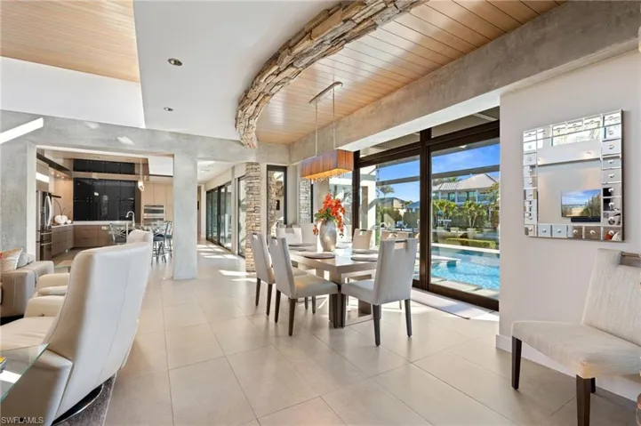 Dining room with light tile patterned floors and wooden ceiling