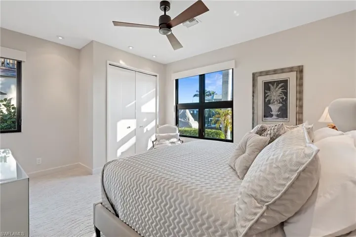 Bedroom featuring carpet floors, a closet, and a ceiling fan