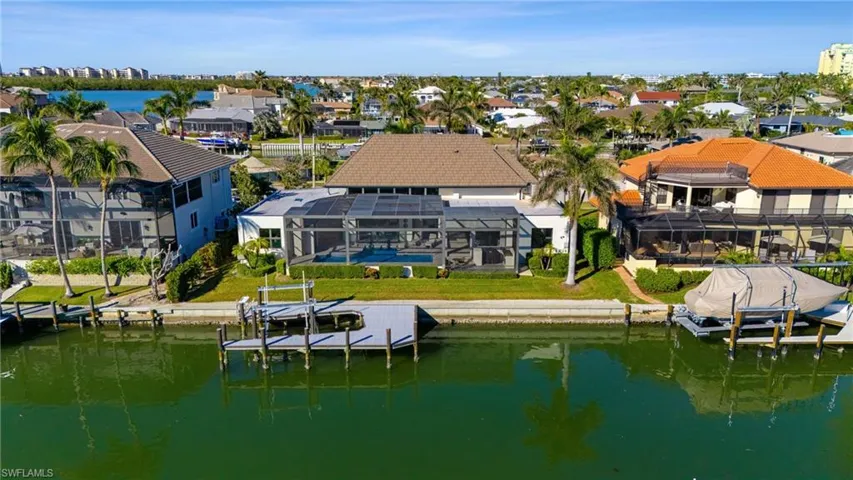 Aerial perspective of suburban area featuring a large body of water