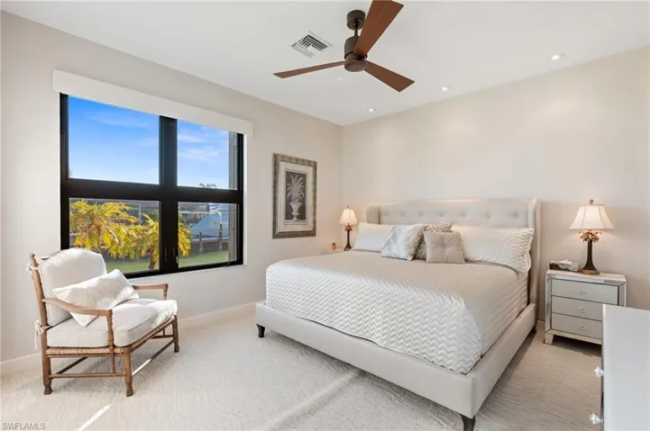 Bedroom with ceiling fan, light colored carpet, and recessed lighting