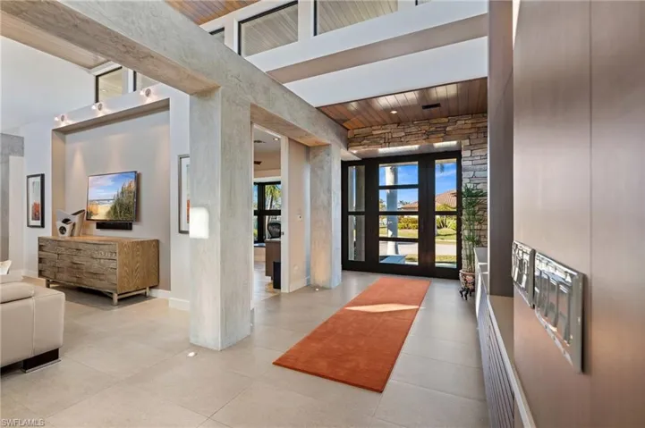 Building lobby featuring a high ceiling and wooden ceiling