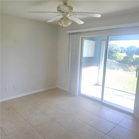 Unfurnished room with a ceiling fan and light tile patterned floors