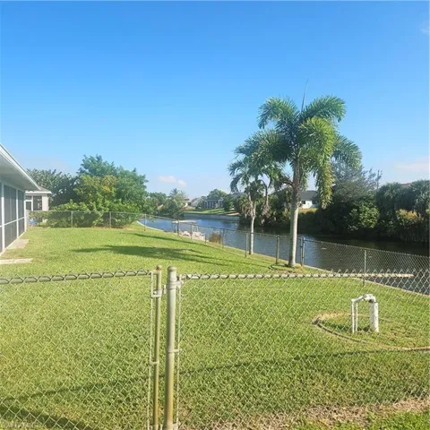 View of yard with a water view and lawncare items