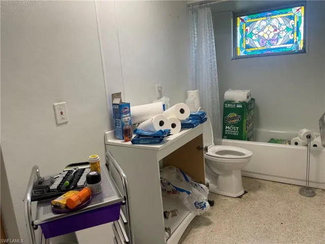 Bathroom with vanity, a tub to relax in, and toilet