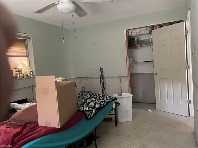 Bedroom with ceiling fan and a closet