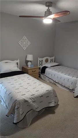 Bedroom with ceiling fan and carpet flooring