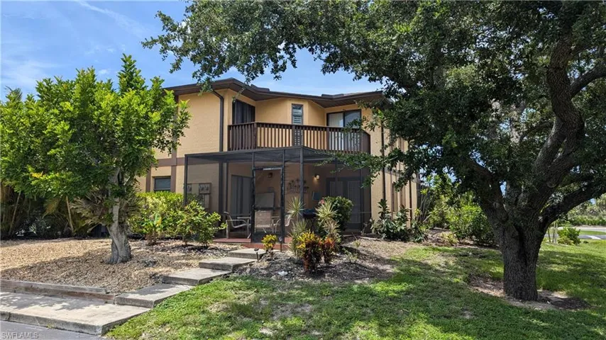View of front of home featuring a balcony and a front lawn
